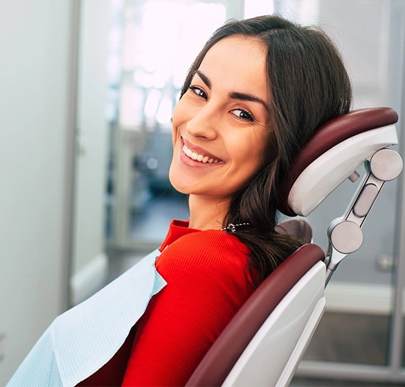 Smiling patient seated in a dental chair during a routine dental visit